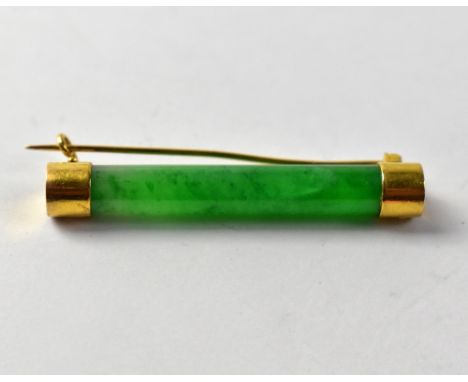 A Chinese cylindrical jade bar brooch with gold caps and pin, marked with Chinese seal either end, length 5cm.