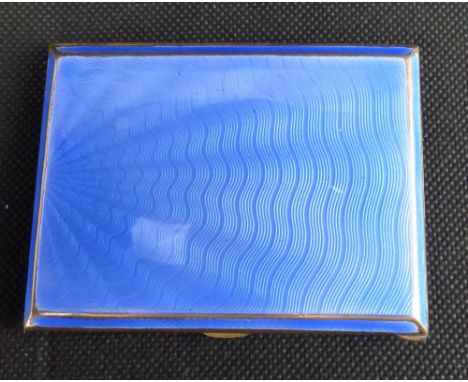 An Art Deco gilt metal and engine turned blue enamel cigarette box, 8.5 x 6.5cm.