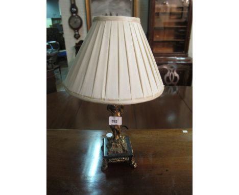 A GILT CHERUB TABLE LAMP raised on a square marble base with scroll legs 45cm high