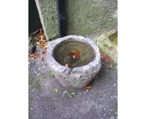 A GRANITE TROUGH of cylindrical tapering form 37cm (h) x 42cm (d)