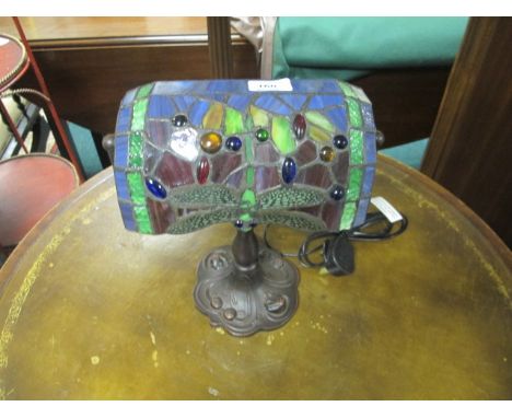 A TIFFANY STYLE ETCHED GLASS TABLE LAMP with multicoloured glass shade above a baluster column on  spreading foot 32cm high 