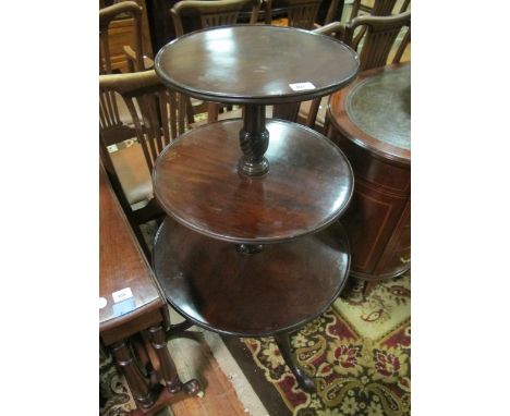 A GEORGIAN MAHOGANY THREE TIER DUMB WAITER each circular dish raised on a spiral twist column and tripod support with pad fee