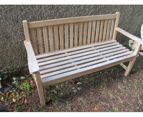 A TEAK GARDEN BENCH with slatted back with seat on square moulded legs 106cm long