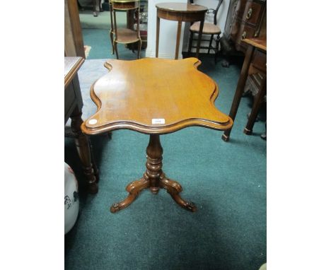 A VICTORIAN MAHOGANY WINE TABLE of serpentine outline the shaped moulded top above a baluster column on tripod support 70cm (