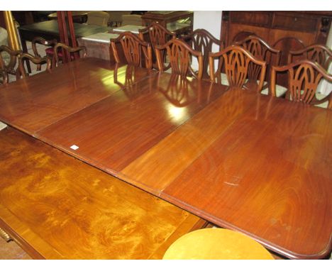 A GOOD GEORGIAN STYLE MAHOGANY TWO POD TABLE the rectangular top with rounded corners and one loose raised on twin tripod sup