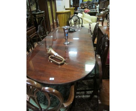 A REGENCY STYLE MAHOGANY D-END DINING TABLE of rectangular form with rounded ends and one loose leaf raised on twin tripod su