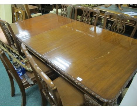 AN EIGHT PIECE CHIPPENDALE STYLE MAHOGANY DINING SUITE comprising six chairs each with a pierced vertical splat above an upho