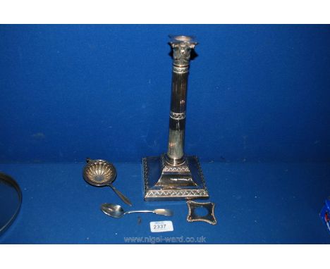 A Silver tea Strainer and a Silver Teaspoon with a plated candlestick
