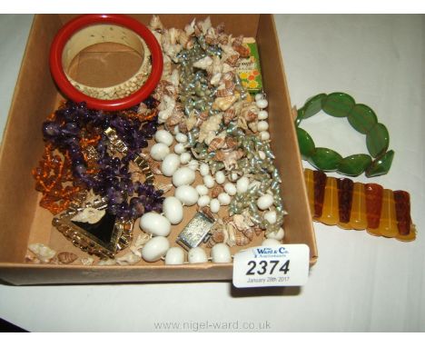 Miscellaneous shell necklaces and vintage plastic/Bakelite bracelets.