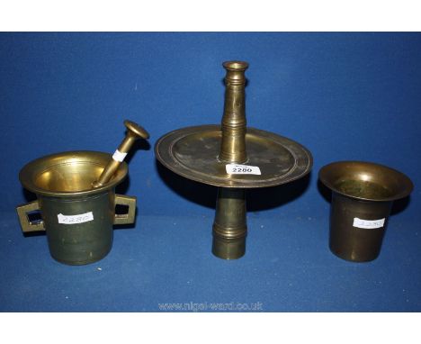 An unusual early brass candlestick with very wide drip pan, a good early 18th century brass mortar with twin knob handles and