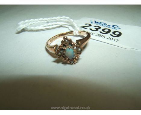 A 9ct. Gold Ring with milk opal and four seed pearls