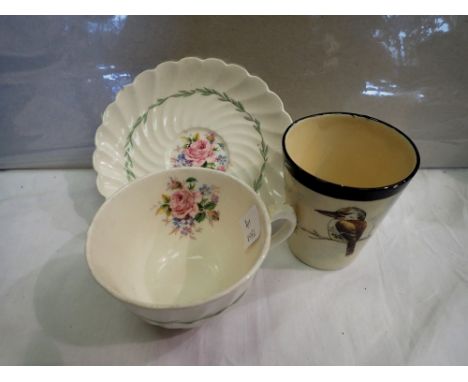 Clarice Cliff cup and saucer and a Royal Doulton cup. P&amp;P Group 2 (£18+VAT for the first lot and £3+VAT for subsequent lo