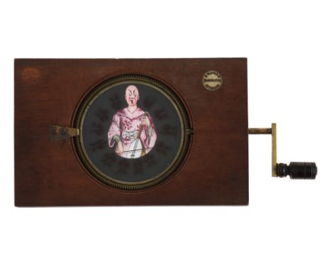 Mechanical Magic Lantern Slide of a musician with Changing Faces, mahogany frame with mechanical geared disk with 13 differen