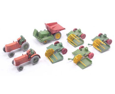 A small collection of Charbens toys including a four-wheeled dump truck, in green and red, two reaper tractors, in orange, on