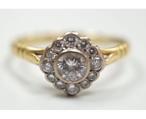 A modern 18ct gold and single stone diamond ring, with diamond set border, size S, gross weight 3.2 grams.