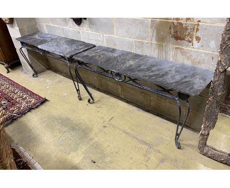 A pair of wrought iron slate top console tables, width 146cm, depth 45cm, height 75cm