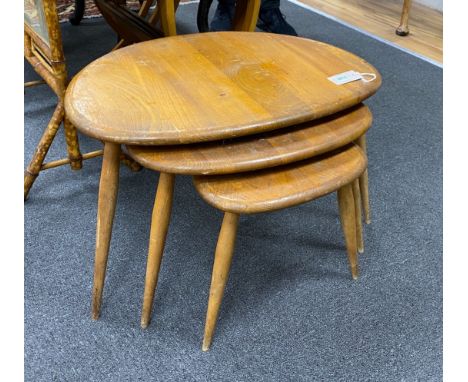 A nest of three Ercol light elm and beech 'pebble'  tables, width 65cm, depth 42cm, height 40cm