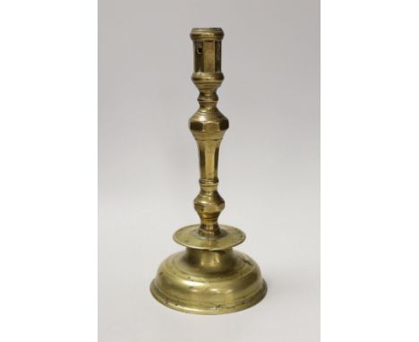 A 17th century continental brass candlestick. 28cm high