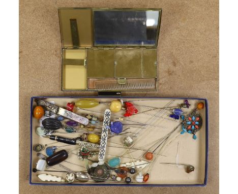 A collection of hat pins and a large enamel compact