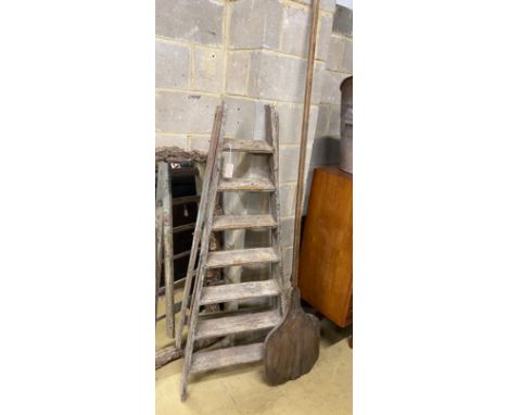 A vintage seven tread wooden step ladder, height 160cm together with a vintage baker's bread paddle