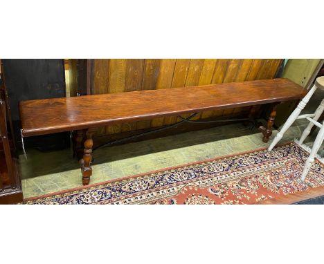 An 18th century style Italian design hardwood bench with wrought iron stretcher, length 213cm, depth 30cm, height 47cm