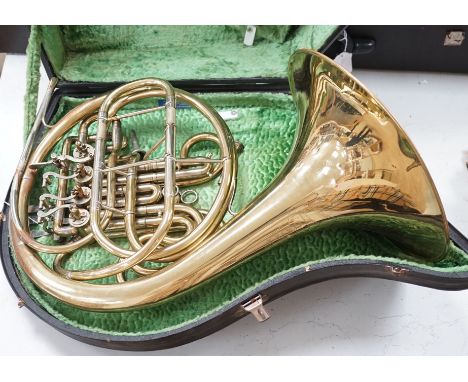 A cased brass telescope and tripod stand, together with a Stanley Toulson French horn (cased)