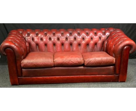 A Tetrad Chesterfield scroll arm three seater sofa, oxblood leather, button back and arms, 204cm long, 70cm high. 