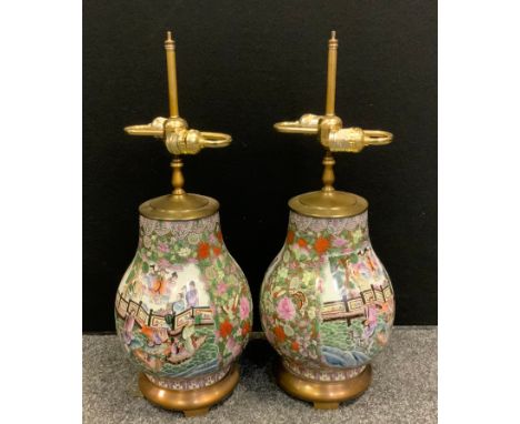 A pair of contemporary Chinese porcelain table lamps, decorated with traditional figures, twin light fittings, 60cm high. 