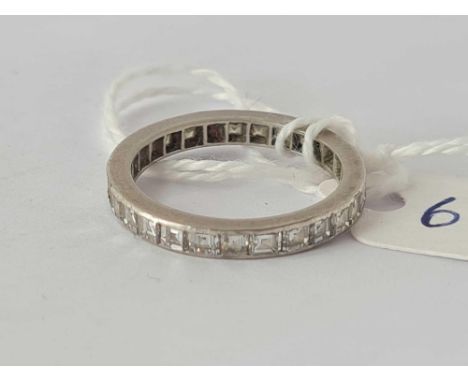 A platinum and baguette diamond eternity ring one stone missing size L   