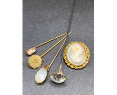 Three gold stick pins cameo pearl and MOP together with a hat pin and cameo brooch