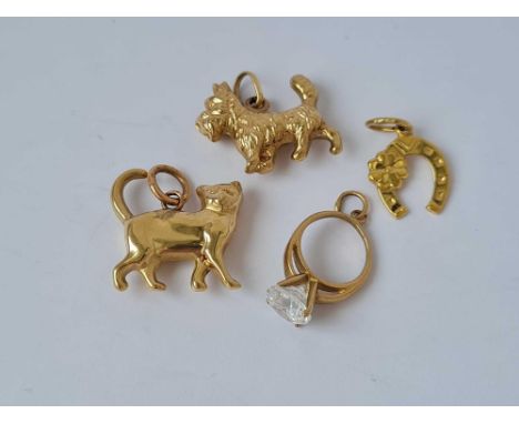 Four gold novelty charms of a dog cat horse shoe and ring 9ct      2.7 gms