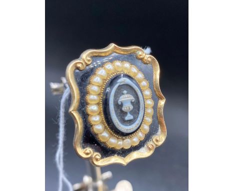 A attractive antique pearl and enamelled memorial brooch with hair locket to reverse dated 1841 in antique box