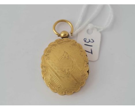 A mid Victorian double opening yellow metal locket with original portrait inside