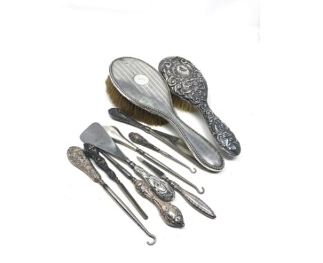 selection of silver items includes brushes shoe horn button hooks etc 