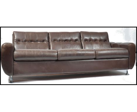 An original 1970's Danish leather sofa raised on chromed legs with scrolled arms and backrests with deep padded leather butto