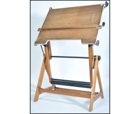A mid century vintage architectural draughtsman board - drawing stand. Raised on beech wood supports with a cast iron counter