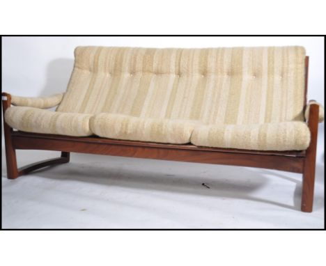 An early 1960's Guy Rogers 'Manhattan style ' teak sofa settee possibly designed by George Fejer and Eric Pamphilo. The teak 