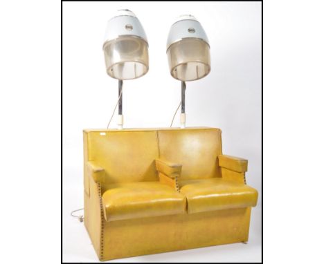 A retro &nbsp;1950's mustard yellow vinyl salon sofa with central elbow rest. The top with circular recess to each side for a