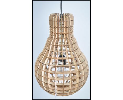 A 20th century contemporary wooden bulb light - lamp. Ceiling hanging having latticed worked shade in the form of a bulb havi