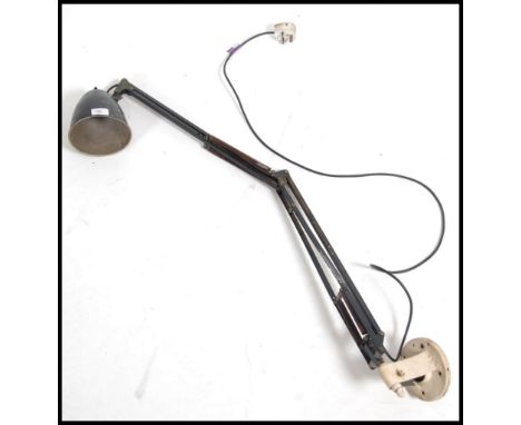 A vintage 1930's early Herbert Terry Industrial anglepoise desk lamp having twin arm with white bracket base and black bell s