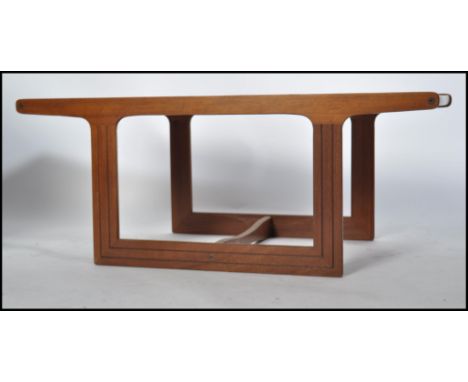 A 1970's retro teak wood and 8 tile top Danish coffee table being of rectangular form having inset 8 tiles raised on chamfere