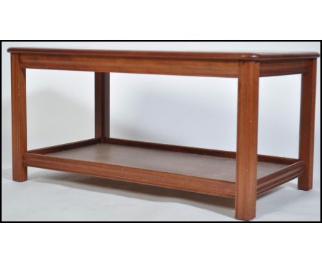 A 1970's teak and twin tile coffee table. The dark teak rectangular body having chamfered leading edgeswith large inset twin 