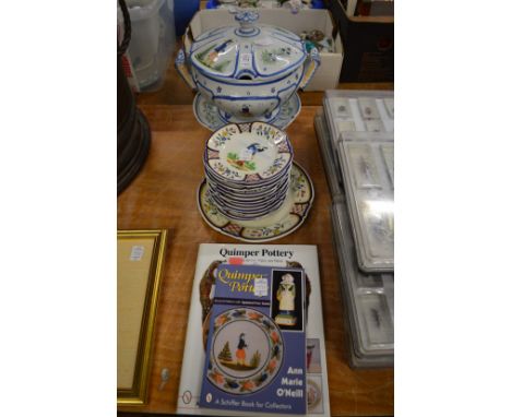 A large Quimper soup tureen, cover and stand together with similar set of plates and two books relating to Quimper pottery.