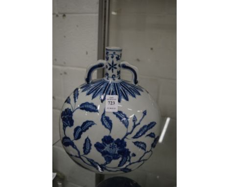 A Chinese blue and white moon flask painted with flowers.