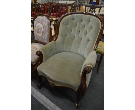 A Victorian mahogany framed button back armchair.