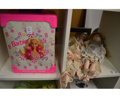 A Barbie trunk and two collectors dolls.