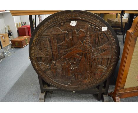 A Chinese carved wood circular fire screen/table.