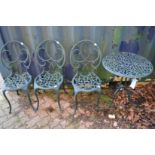 A small green painted aluminium circular patio table and three chairs.