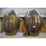 A pair of large stylish metal ceiling lights.