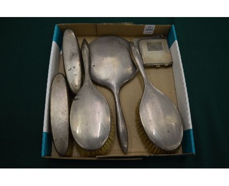 A silver compact and silver dressing table set.